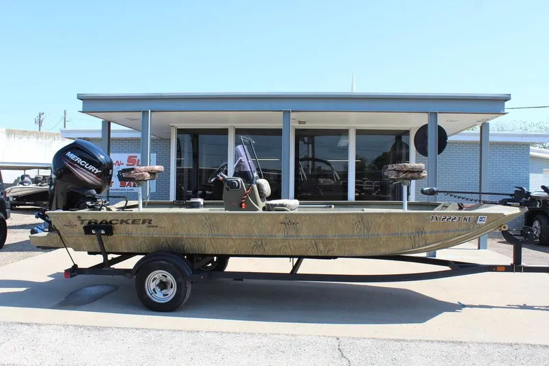 Slide: The Image of 2018 Tracker GRIZZLY® 1860 CC boat on trailer, parked outside a building. - 13