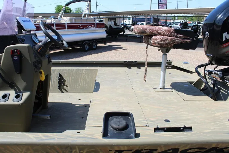Slide: The Image of 2018 Tracker GRIZZLY® 1860 CC boat interior with steering console and camo seat. - 2