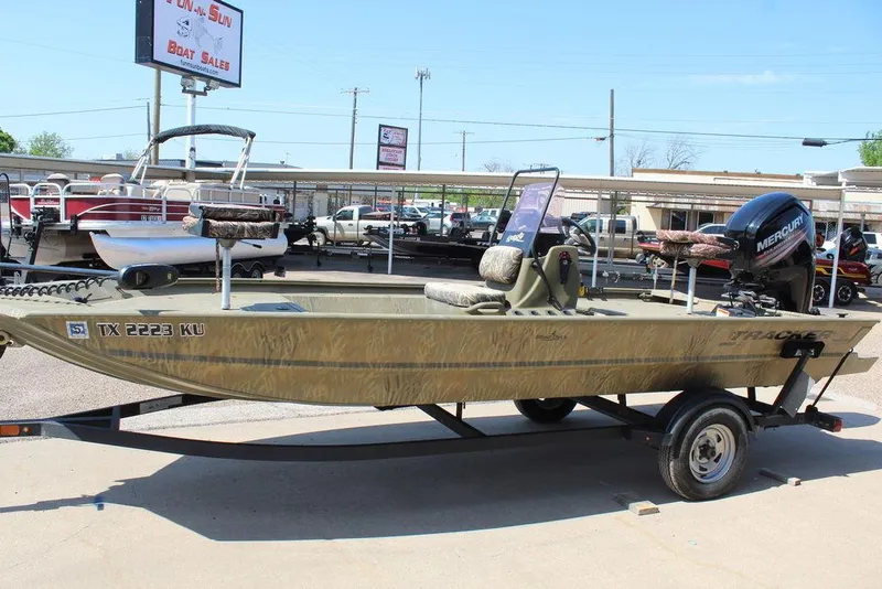 Slide: The Image of 2018 Tracker GRIZZLY® 1860 CC boat on trailer, displayed at a dealership. - 8