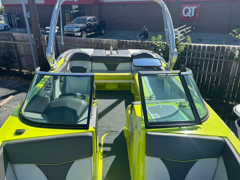 Slide: The Image of 2018 MasterCraft XT22 boat with vibrant yellow exterior and sleek interior design. - 11
