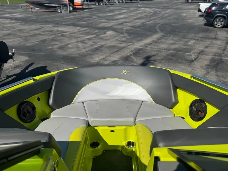 Slide: The Image of 2018 MasterCraft XT22 boat interior with gray and lime green seating. - 13
