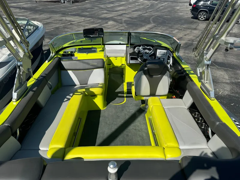 Slide: The Image of 2018 MasterCraft XT22 boat interior with vibrant yellow and gray seating. - 15