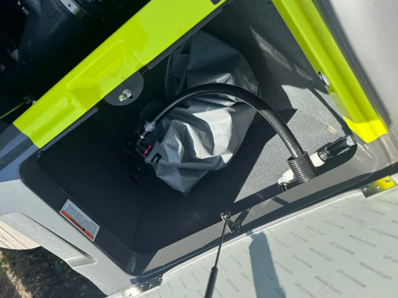 Slide: The Image of Storage compartment of a 2018 MasterCraft XT22 boat with hose and cover inside. - 17