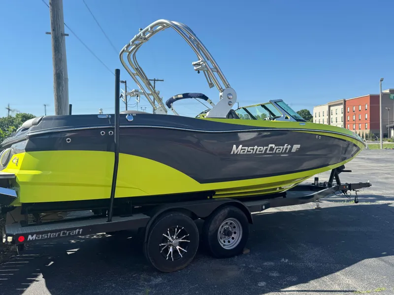 Slide: The Image of 2018 MasterCraft XT22 boat in vibrant yellow and gray on a trailer. - 5