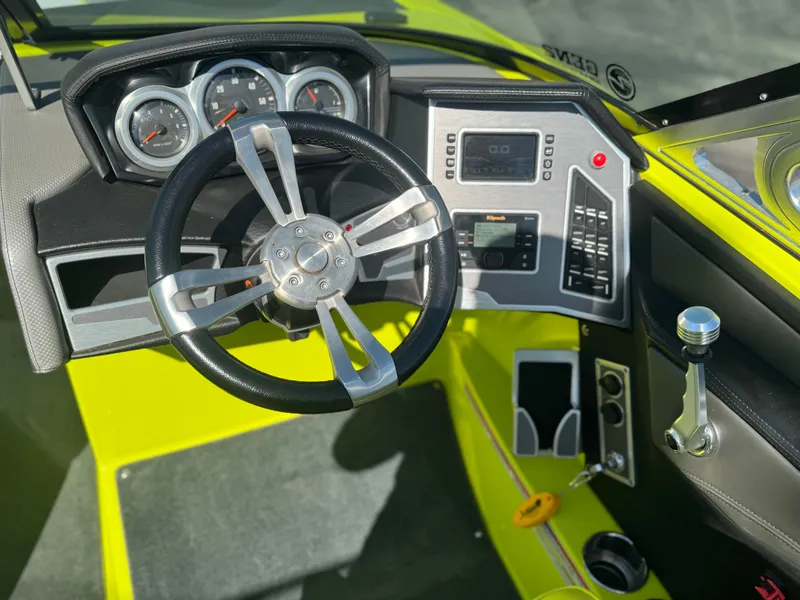 Slide: The Image of Cockpit of 2018 MasterCraft XT22 boat with steering wheel and control panel. - 6