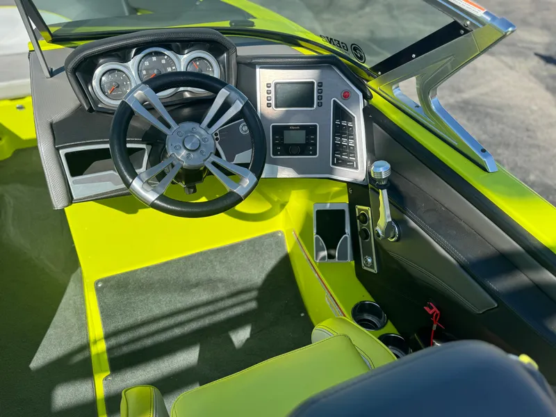 Slide: The Image of 2018 MasterCraft XT22 boat cockpit with modern steering and control panel. - 9