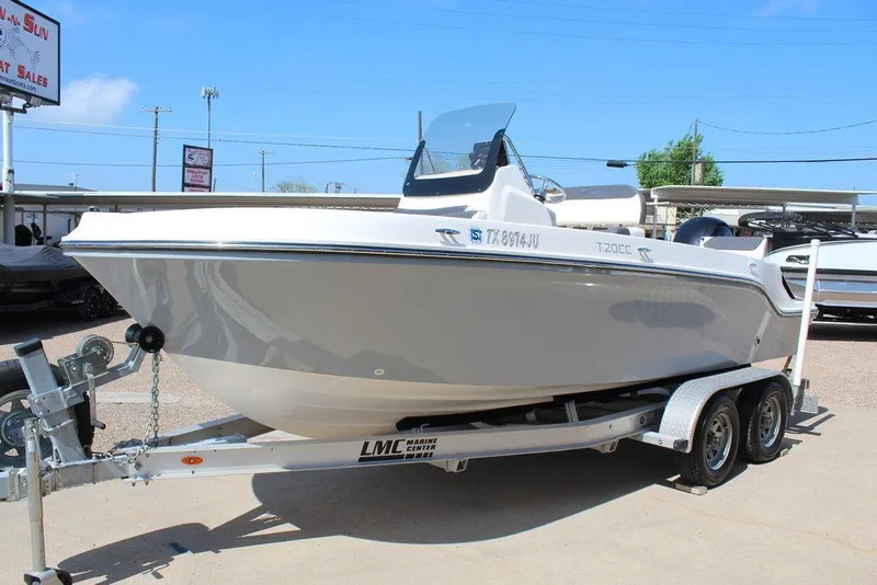 Slide: The Image of 2021 Bayliner T20CC boat on trailer, displayed outdoors under clear sky. - 10