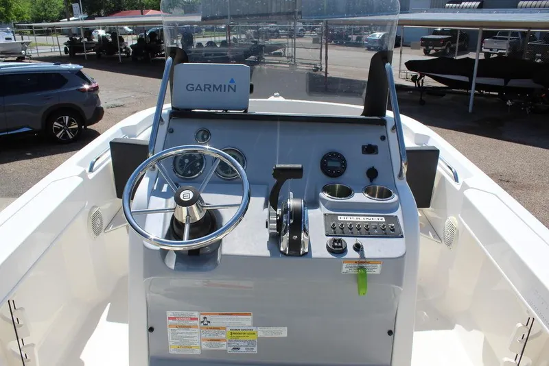 Slide: The Image of 2021 Bayliner T20CC boat dashboard with Garmin navigation system and steering wheel. - 11