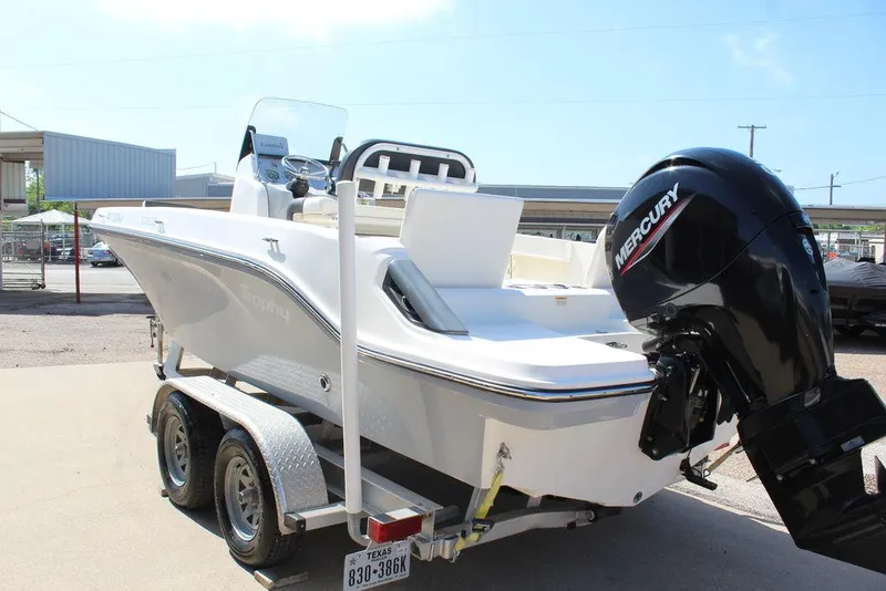 Slide: The Image of 2021 Bayliner T20CC boat on trailer with Mercury outboard motor, parked outdoors. - 12