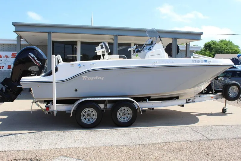 Slide: The Image of 2021 Bayliner T20CC boat on trailer, parked outdoors, side view. - 14