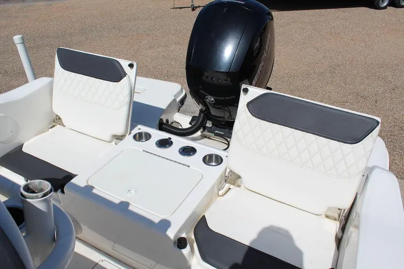 Slide: The Image of 2021 Bayliner T20CC boat interior with dual seats and motor. - 2