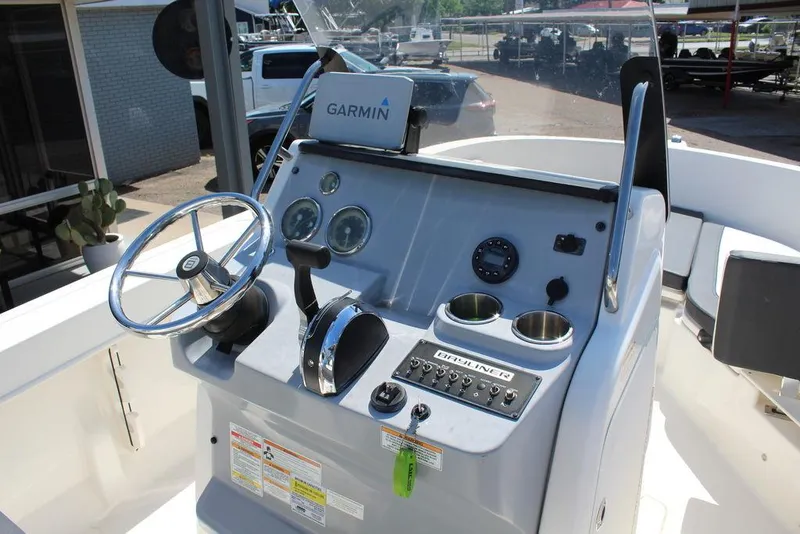 Slide: The Image of 2021 Bayliner T20CC boat console with Garmin GPS, steering wheel, and controls. - 8