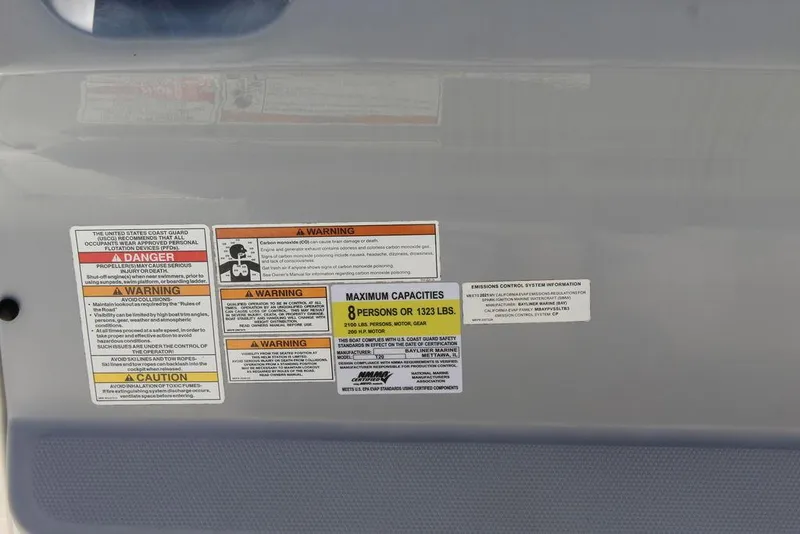 Slide: The Image of Safety and capacity labels on 2021 Bayliner T20CC boat, indicating maximum of 8 persons or 1323 lbs. - 9