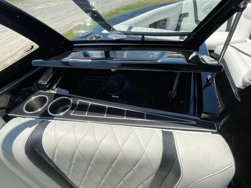 Slide: The Image of Interior of 2021 Tigé 23ZX boat with sleek black and white seating and cup holders. - 11