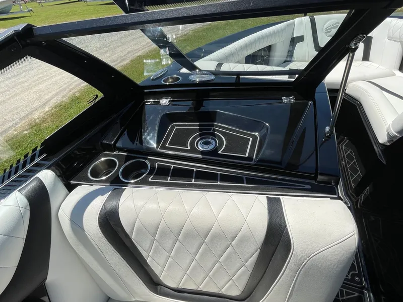 Slide: The Image of 2021 Tigé 23ZX boat interior with sleek black and white seating and cup holders. - 12