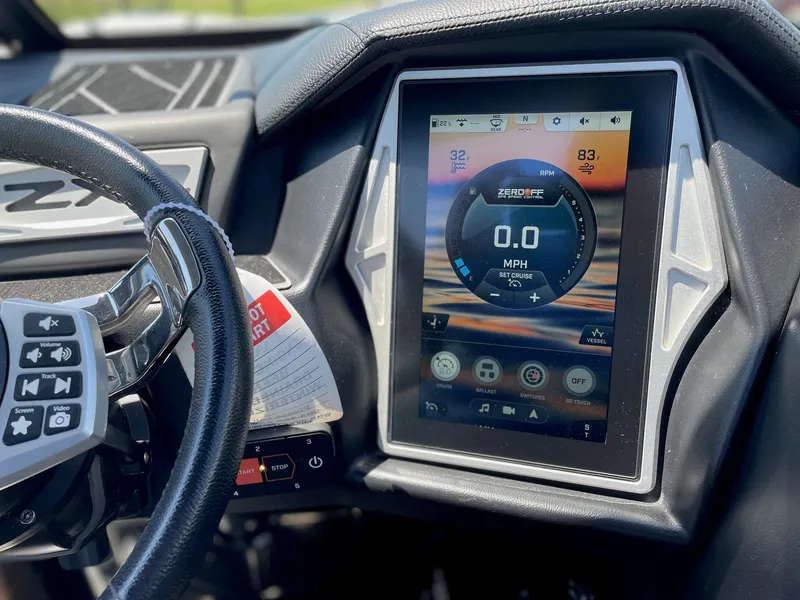 Slide: The Image of 2021 Tigé 23ZX boat dashboard with touchscreen display showing speed and controls. - 17