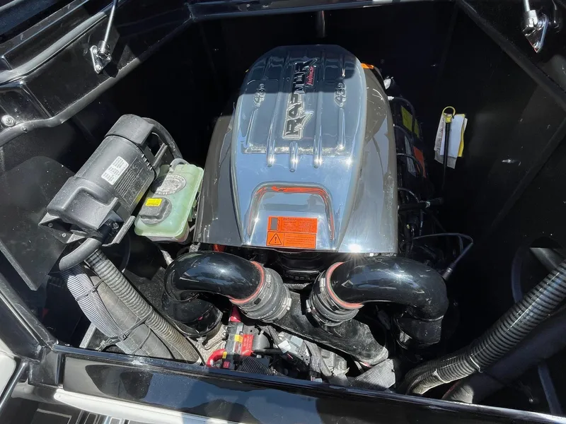 Slide: The Image of Engine compartment of a 2021 Tigé 23ZX boat, featuring a powerful inboard motor. - 19