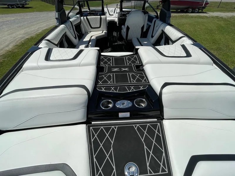 Slide: The Image of 2021 Tigé 23ZX boat interior with luxurious white seating and stylish black accents. - 4