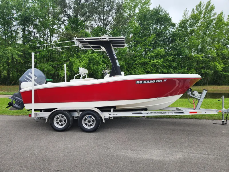 Slide: The Image of 2008 Pioneer 197 Sportfish boat on trailer, red and white, parked on road. - 0