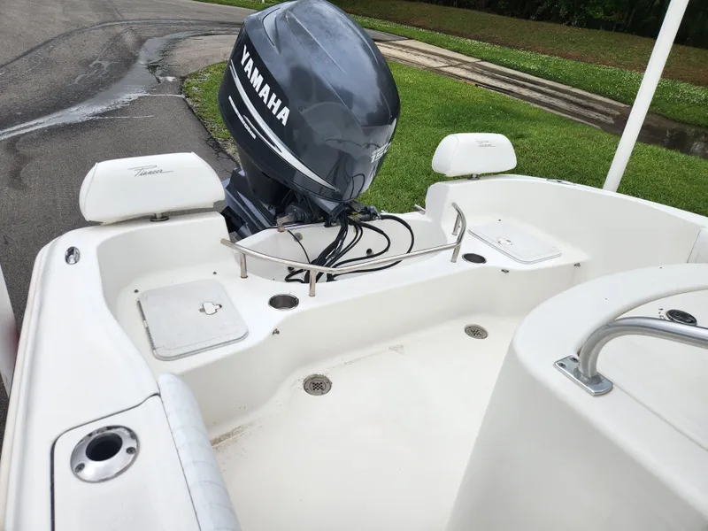 Slide: The Image of 2008 Pioneer 197 Sportfish boat with Yamaha outboard motor, parked on a wet road. - 12