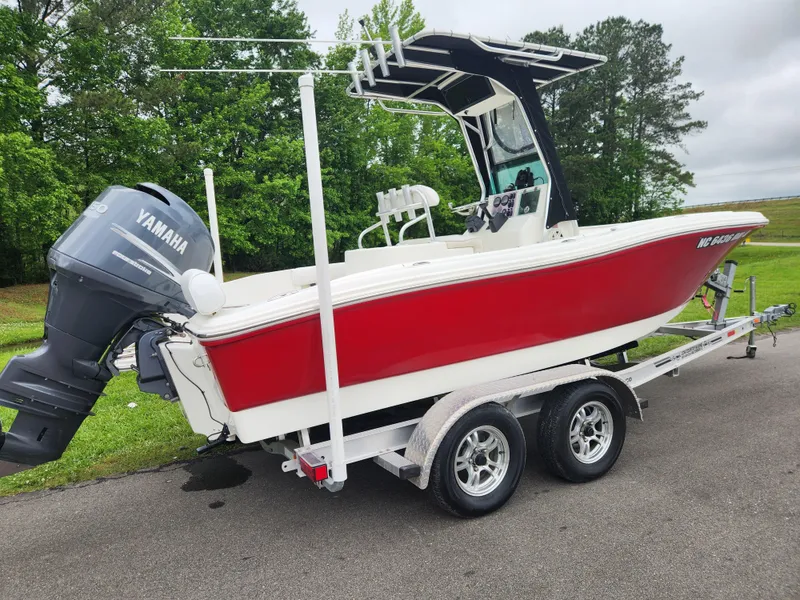 Slide: The Image of 2008 Pioneer 197 Sportfish boat with Yamaha motor on a trailer, parked outdoors. - 2