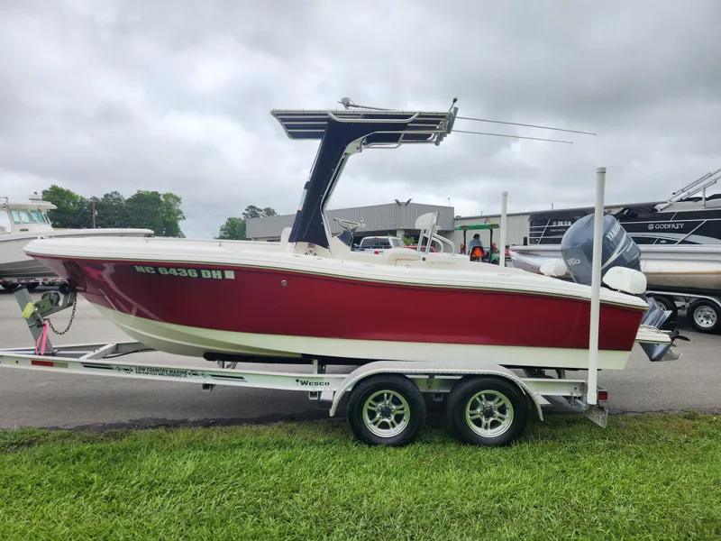 Slide: The Image of 2008 Pioneer 197 Sportfish boat on trailer, red and white, parked outdoors. - 6