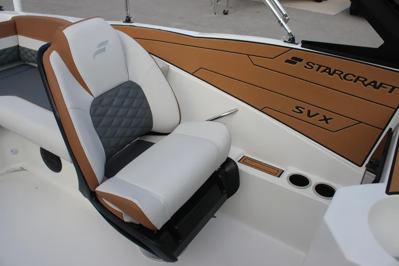 Slide: The Image of 2025 Starcraft SVX 210 OB DC boat interior with cushioned seating and stylish design. - 11