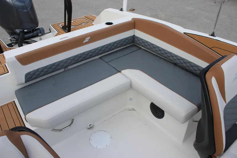 Slide: The Image of 2025 Starcraft SVX 210 OB DC boat interior with cushioned seating and modern design. - 12