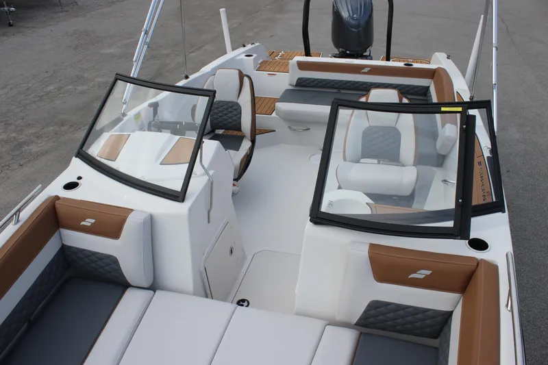 Slide: The Image of 2025 Starcraft SVX 210 OB DC boat interior with modern seating and sleek design. - 13