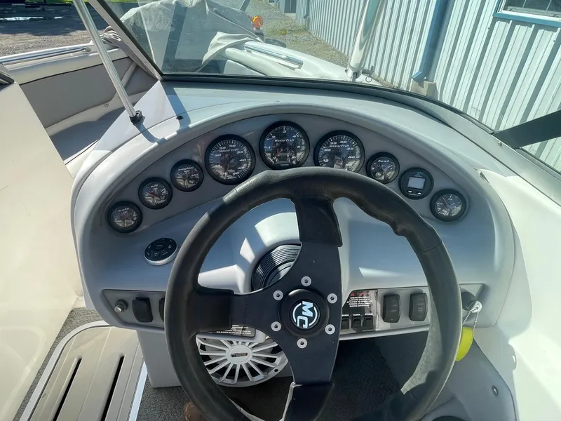 Slide: The Image of 1999 MasterCraft Prostar 205 dashboard with steering wheel and gauges. - 8