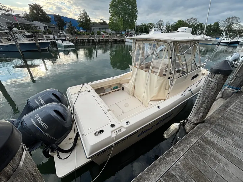 Slide: The Image of 2021 Grady-White Gulfstream 232 boat docked with twin Yamaha engines. - 13