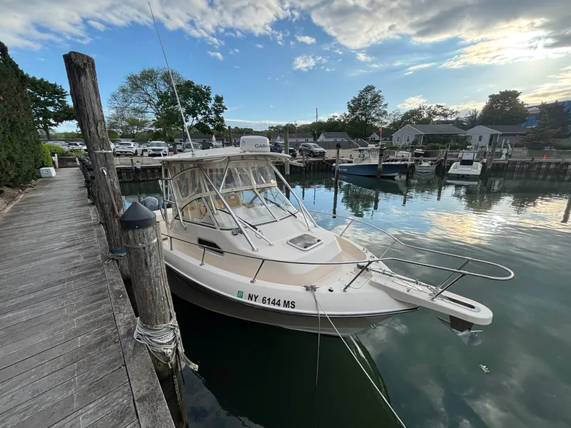Slide: The Image of 2021 Grady-White Gulfstream 232 boat docked in a serene marina setting. - 17