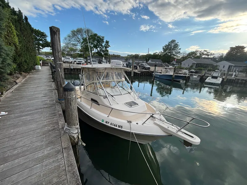 Slide: The Image of 2021 Grady-White Gulfstream 232 boat docked at a serene marina. - 18