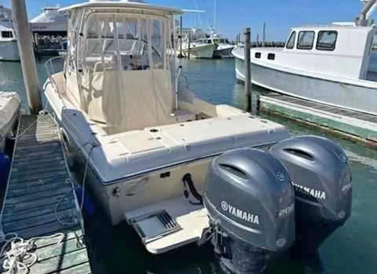 Slide: The Image of 2021 Grady-White Gulfstream 232 boat docked with twin Yamaha engines. - 2