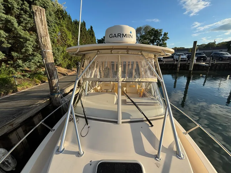 Slide: The Image of 2021 Grady-White Gulfstream 232 boat docked, featuring Garmin equipment and clear skies. - 20