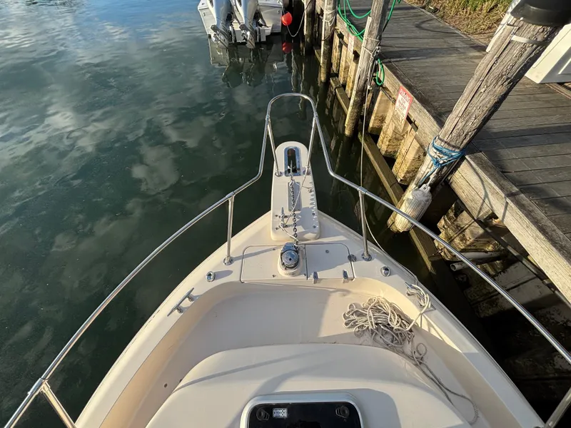 Slide: The Image of Bow view of 2021 Grady-White Gulfstream 232 docked by wooden pier. - 23