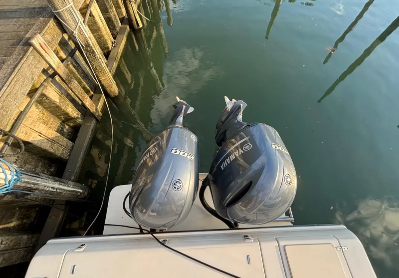 Slide: The Image of Twin Yamaha outboard engines on a 2021 Grady-White Gulfstream 232 at a dock. - 24