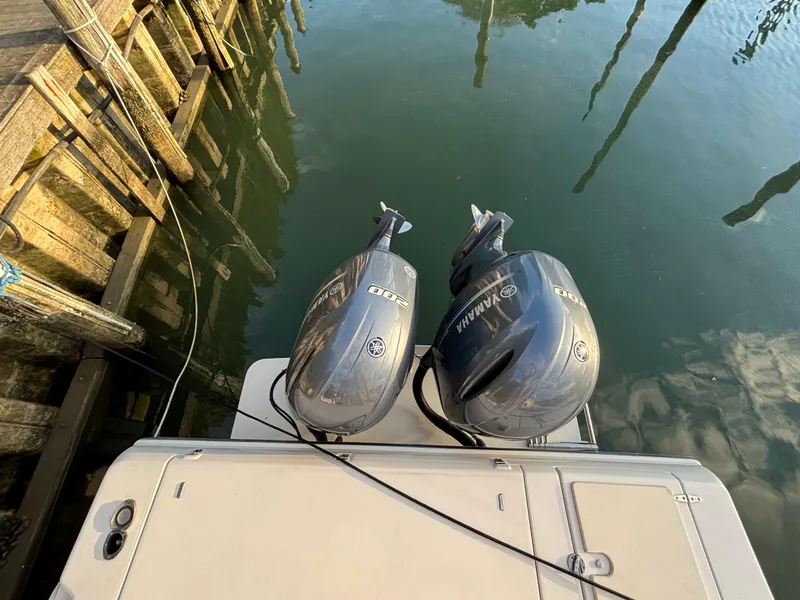 Slide: The Image of Twin Yamaha outboard engines on a 2021 Grady-White Gulfstream 232 boat at dock. - 26