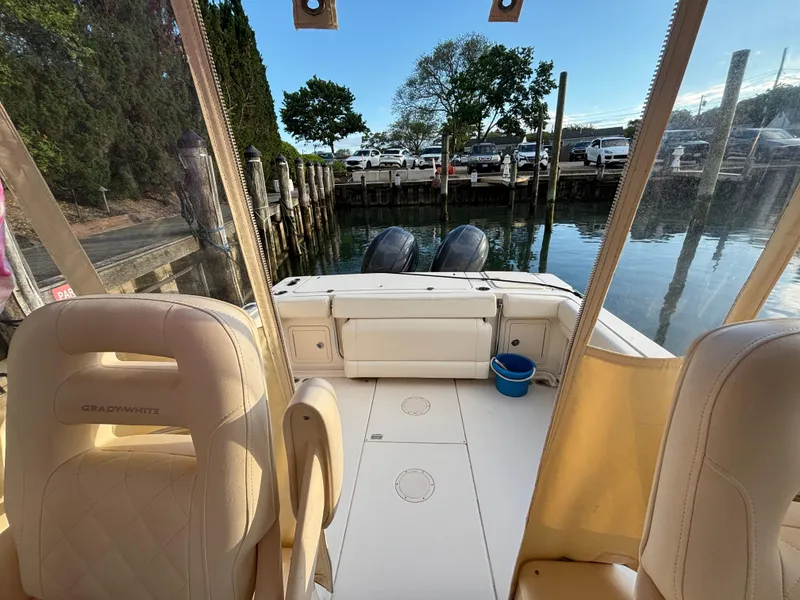 Slide: The Image of 2021 Grady-White Gulfstream 232 boat interior, docked with dual engines, calm water view. - 32