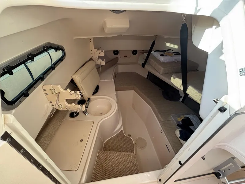 Slide: The Image of 2021 Grady-White Gulfstream 232 cabin interior with seating, sink, and window. - 34