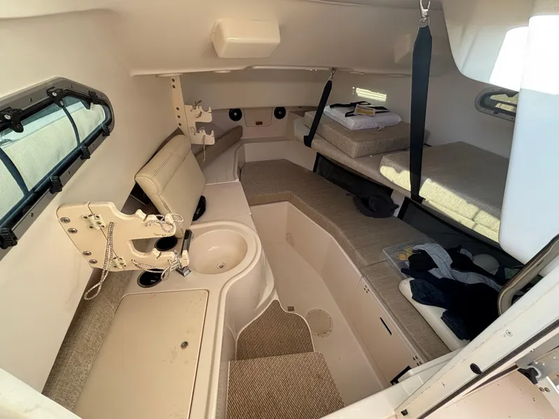 Slide: The Image of 2021 Grady-White Gulfstream 232 cabin interior with seating and storage. - 35