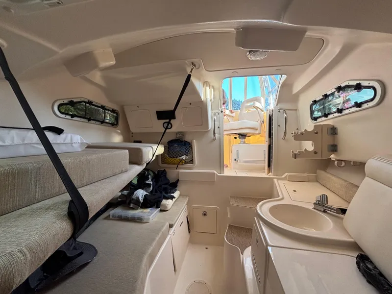 Slide: The Image of Interior of 2021 Grady-White Gulfstream 232 boat, featuring seating and compact amenities. - 36