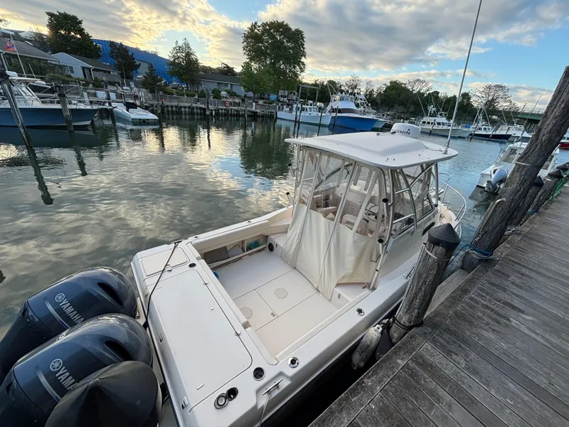 Slide: The Image of 2021 Grady-White Gulfstream 232 boat docked with twin Yamaha engines, scenic marina view. - 38