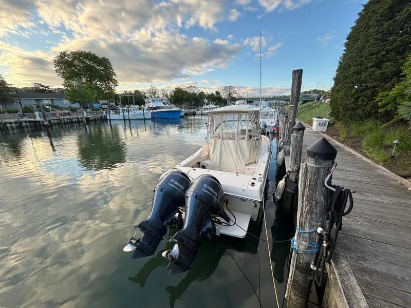 Slide: The Image of 2021 Grady-White Gulfstream 232 boat docked by a scenic waterfront. - 40