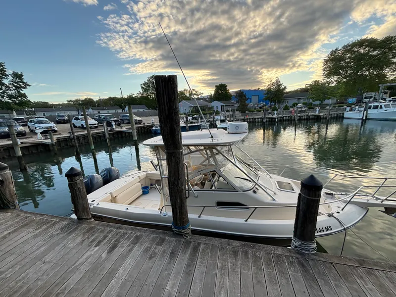 Slide: The Image of 2021 Grady-White Gulfstream 232 docked at a marina during sunset. - 42