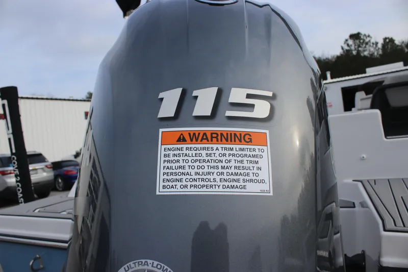 Slide: The Image of 2025 Starcraft SVX 191 OB boat engine with warning label and 115 horsepower marking. - 4