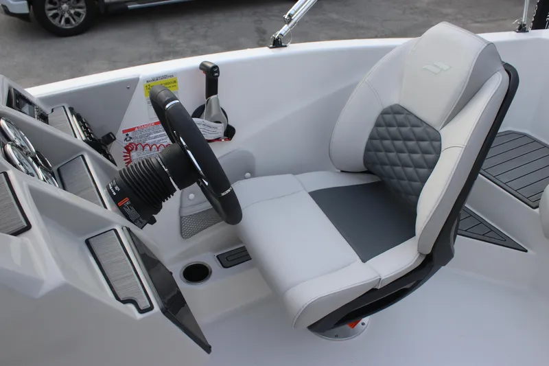 Slide: The Image of 2025 Starcraft SVX 191 OB boat cockpit with modern steering and comfortable seating. - 8