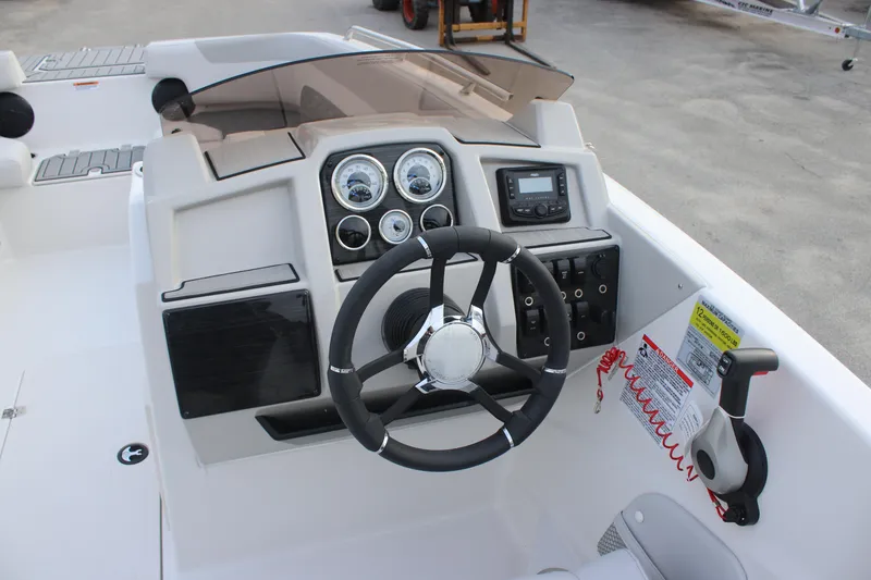 Slide: The Image of 2025 Starcraft SVX 191 OB boat dashboard with steering wheel and control panel. - 9