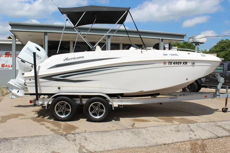 The Image of 2022 Hurricane SunDeck Sport 192 RL OB boat on trailer, parked outdoors. - 0