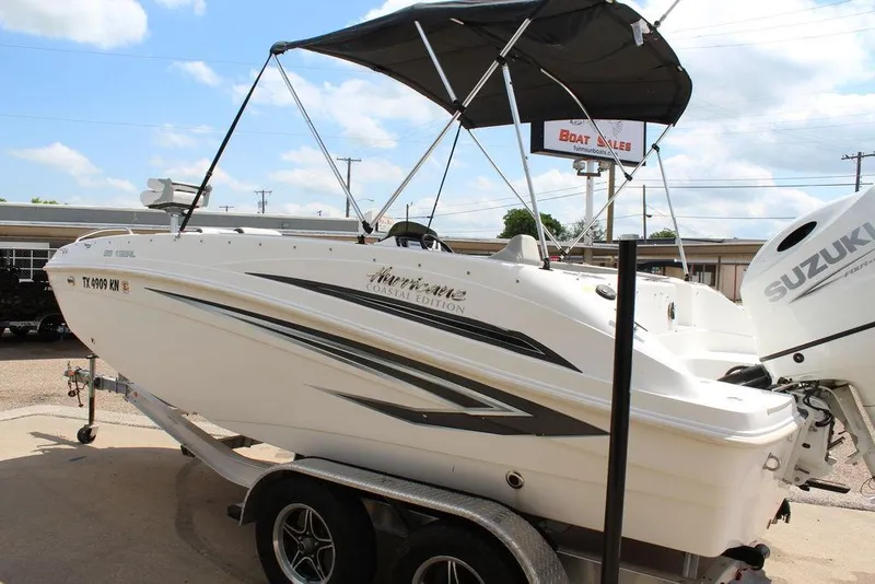 Slide: The Image of 2022 Hurricane SunDeck Sport 192 RL OB boat on trailer, featuring a Suzuki outboard motor. - 10